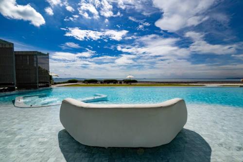 a white boat sitting in the middle of a swimming pool at Good Living By Veranda Residence Pattaya in Na Jomtien