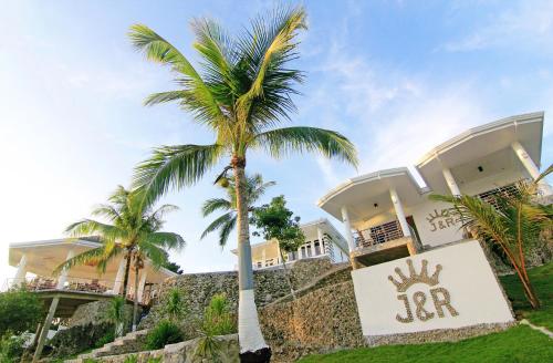 a palm tree in front of a building at J&R Residence in Anda