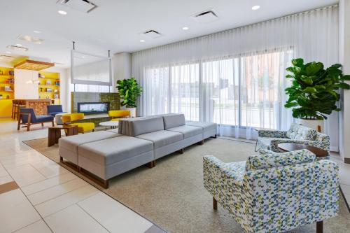 a living room with a couch and chairs at Hotel Indigo Detroit Downtown, an IHG Hotel in Detroit