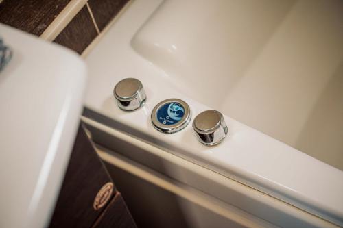 a bathroom with two knobs on a tub at Mikra Anogia Villas in Rethymno Town