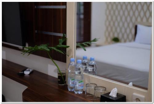 a group of bottles on a counter in a bedroom at RedDoorz Syariah at Omah Sawah in Balong
