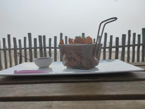 a plate with a cup and a basket on a table at Buena Vida Beach Resort in Morjim