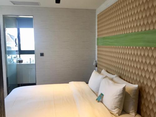 Postel nebo postele na pokoji v ubytování Fengjia Hotel Bell