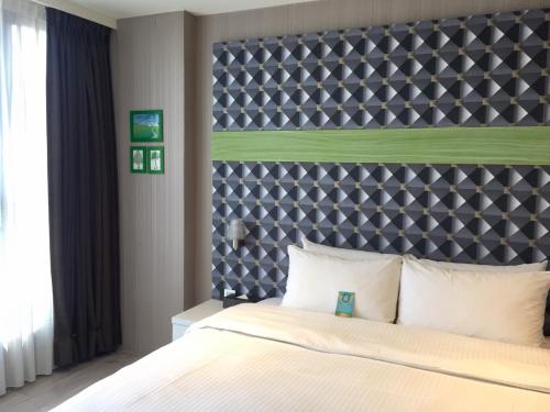 Postel nebo postele na pokoji v ubytování Fengjia Hotel Bell