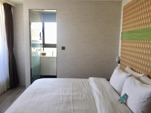 Postel nebo postele na pokoji v ubytování Fengjia Hotel Bell