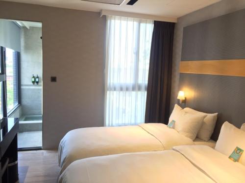 Postel nebo postele na pokoji v ubytování Fengjia Hotel Bell
