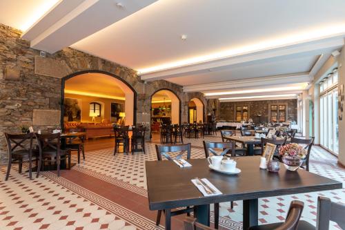 a restaurant with tables and chairs in a room at Burg Reichenstein in Trechtingshausen