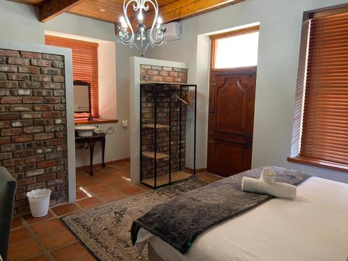 Ένα ή περισσότερα κρεβάτια σε δωμάτιο στο Olive Tree Lodge