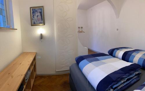 a room with two beds and a wooden table at Rustic Overnight Apartment in Osterholz-Scharmbeck