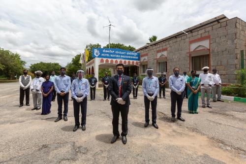 a group of people standing in front of a building at KSTDC Hotel Mayura Bhuvaneshwari Kamalapur in Hampi