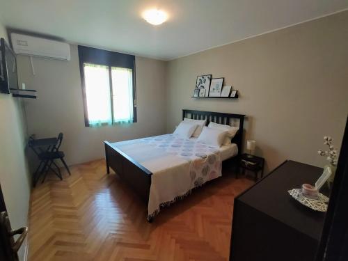a bedroom with a large bed and a table at Apartments Villa Sabina in Pula