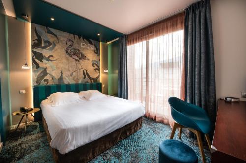 a hotel room with a bed and a large window at Best Western Aquakub in Aix-les-Bains