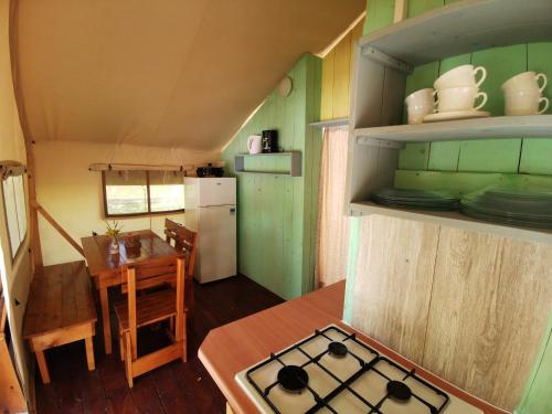 a kitchen with a stove, sink, and cabinets at Sunflower Camping in Novigrad Istria