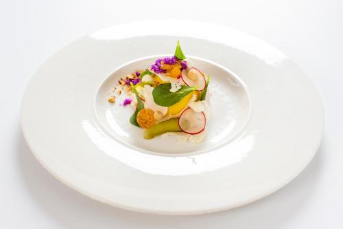 a plate of food on a white plate at Relais & Chateaux Hotel Landgoed Het Roode Koper in Ermelo