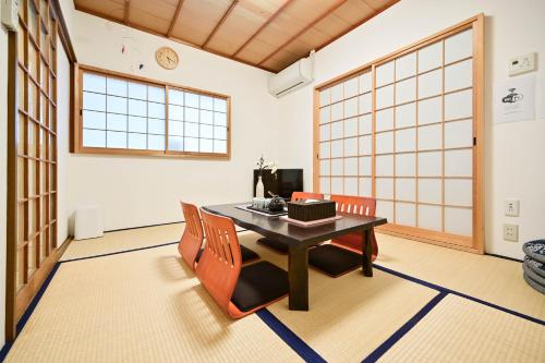a dining room with a table and two chairs at 鴨川 栄の屋 Kamo River Machiya Halo House in Kyoto