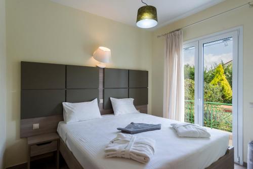 a bedroom with a large bed with towels on it at Sun, Sand, & Seclusion - Artemis with Private Pool in Finikounta
