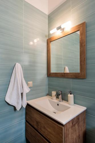 a bathroom with a sink and a mirror at Sun, Sand, & Seclusion - Artemis with Private Pool in Finikounta