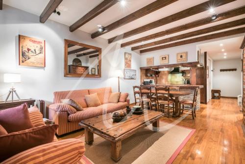 a living room with a couch and a table at Amitges by SeaMount Rentals in Baqueira-Beret