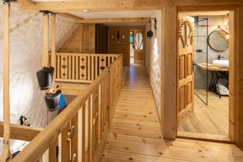 a wooden staircase in a log cabin with wooden floors at Horna Koliba in Poronin