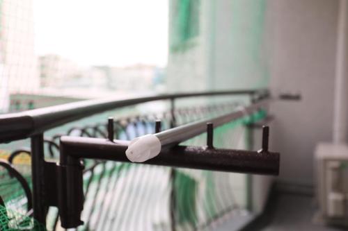a black railing with a white object on it at ケイアイコンホテルズ 池下 in Chikusachō