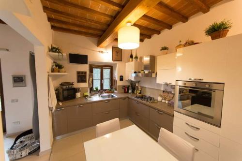 a kitchen with a sink and a stove top oven at VILLORE - Home Sweet Home Tuscany in Poggibonsi