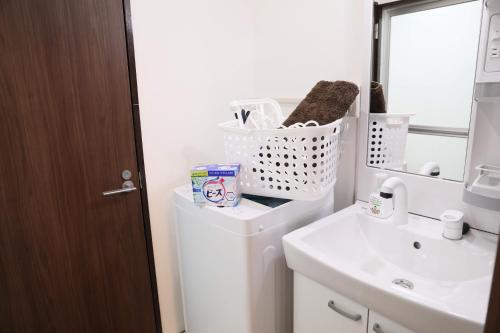 a bathroom with a toilet and a sink at ケイアイコンホテルズ 池下 in Chikusachō