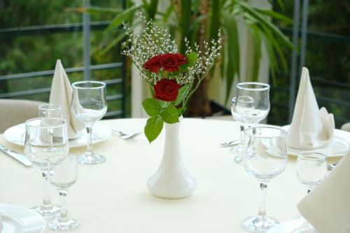a table topped with vases filled with flowers at Hotel Ternopil in Ternopil