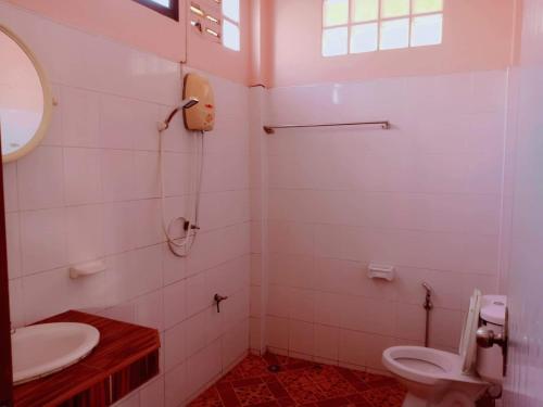 a bathroom with a toilet and a sink at Silver Beach Bungalow in Haad Yao