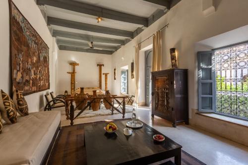 a living room with a couch and a table at Riad Tchaikana in Marrakech