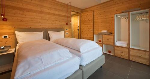 a bedroom with a large bed in a wooden room at Cronox Vinecc in Livigno