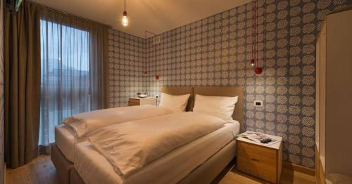 a bedroom with a bed and a large window at Cronox Vinecc in Livigno