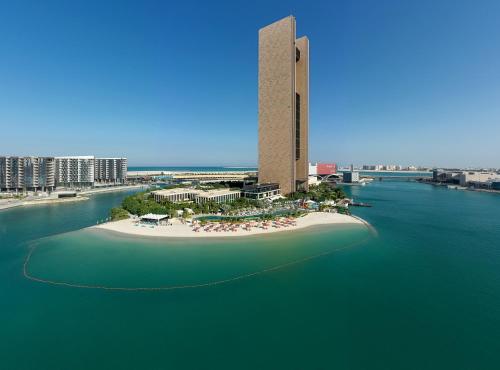 a large body of water with a clock tower at Four Seasons Hotel Bahrain Bay in Manama
