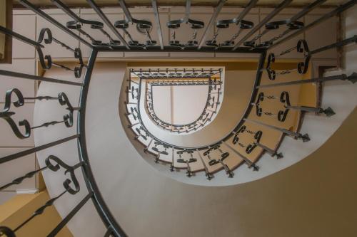 a large stairway with several pieces of art on it at Hostal San Cayetano in Ronda