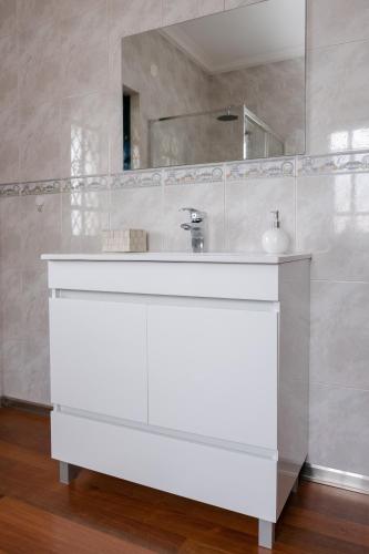 a bathroom with a white sink and a mirror at Classico Guesthouse in Vila Nova de Gaia