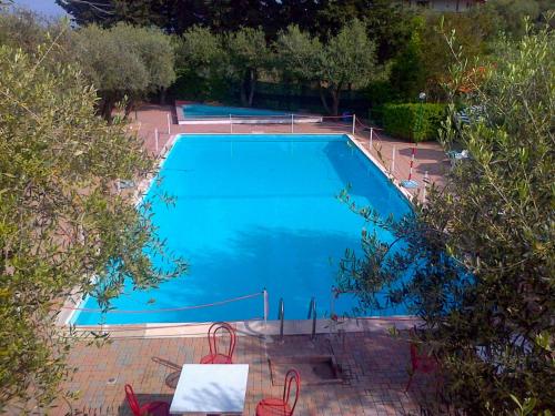 an overhead view of a large blue swimming pool at Apartment Borgoverde-2 by Interhome in Imperia