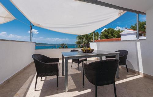 Una mesa y sillas en un balcón con vista al mar. en Apartments Lord Pirovac, en Pirovac
