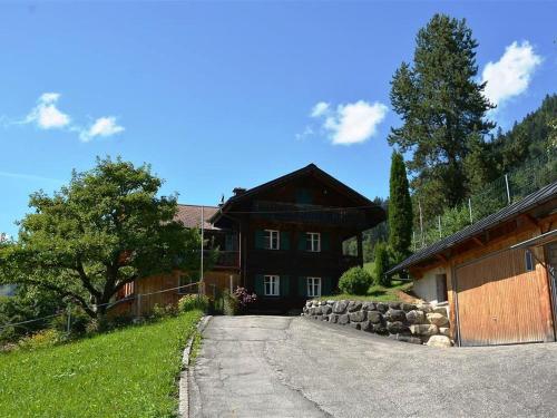 una casa con una carretera que conduce a un edificio en Apartment Meielblick by Interhome en Gstaad