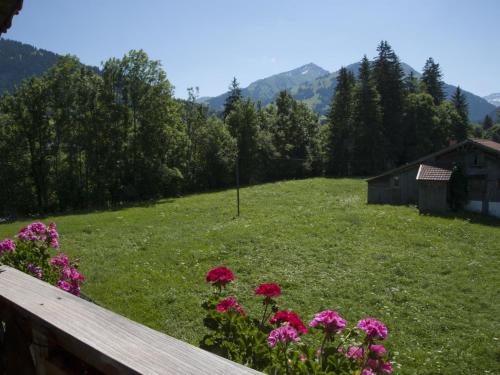 a field with pink flowers on a wooden fence at Apartment Steimandli by Interhome in Gstaad