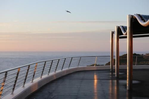 a boardwalk leading to the ocean on a cruise ship at Alàbriga Hotel GL in S'Agaro