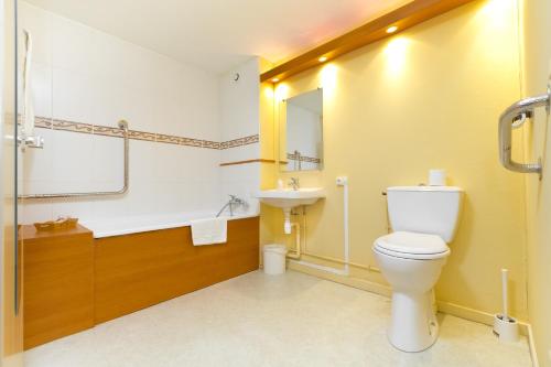 a bathroom with a toilet and a sink at Prest'Hôtel Epinal in Épinal