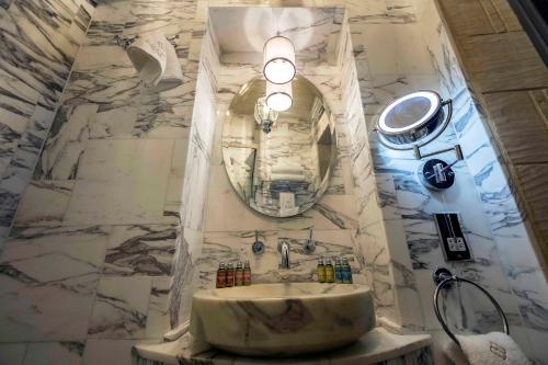 a bathroom with a sink and a large mirror at Lulu Boutique Hotel in Żebbuġ