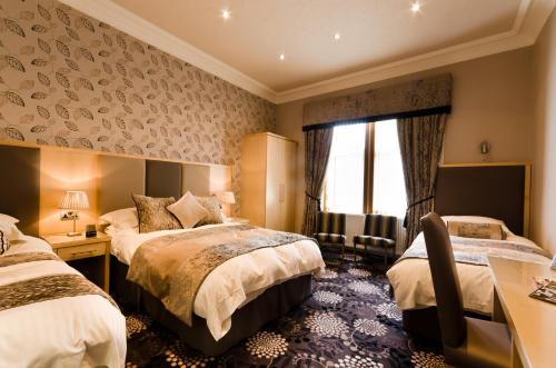 En eller flere senge i et værelse på Inverlea Guest House