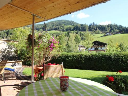 a table on a patio with a view of a field at Apartment Dahoam-1 by Interhome in Forstau