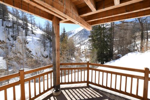 a view from the porch of a cabin in the snow at Gîte Ancolie Bleue in Abriès