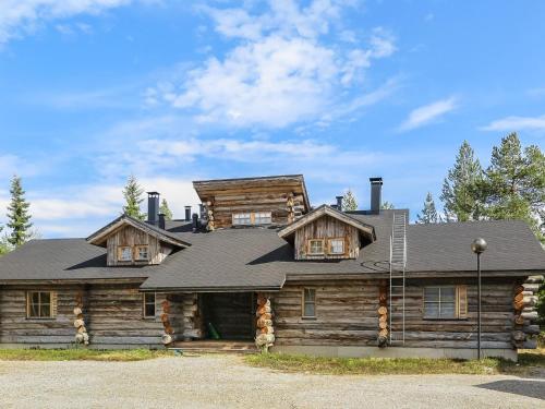 a log cabin house with a gambrel roof at Holiday Home Tokkapirtti 3 by Interhome in Sirkka