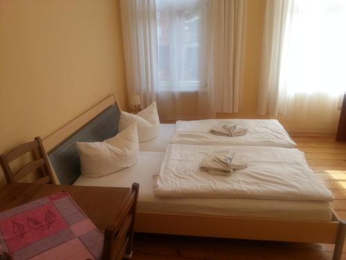 a bedroom with a bed with two napkins on it at Hotel-Café-Burg Stahleck in Bacharach