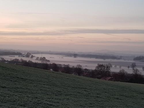 a hill with a view of a field and a river at Gasthaus Winkelvoß in Einbeck
