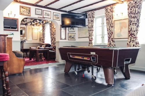 a living room with a pool table in a room at The Rest and Be Thankful Inn in Minehead