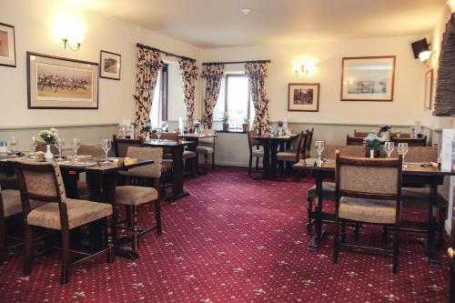 a restaurant with tables and chairs in a room at The Rest and Be Thankful Inn in Minehead