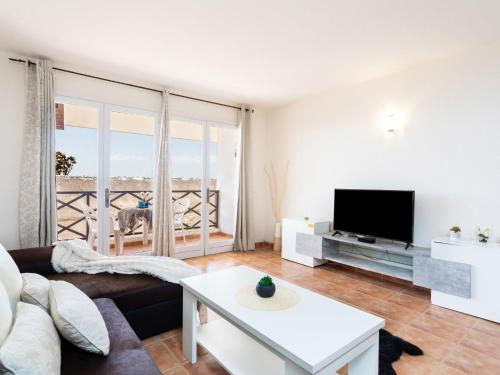 TV a/nebo společenská místnost v ubytování Apartment Cozy Neptuno by Interhome